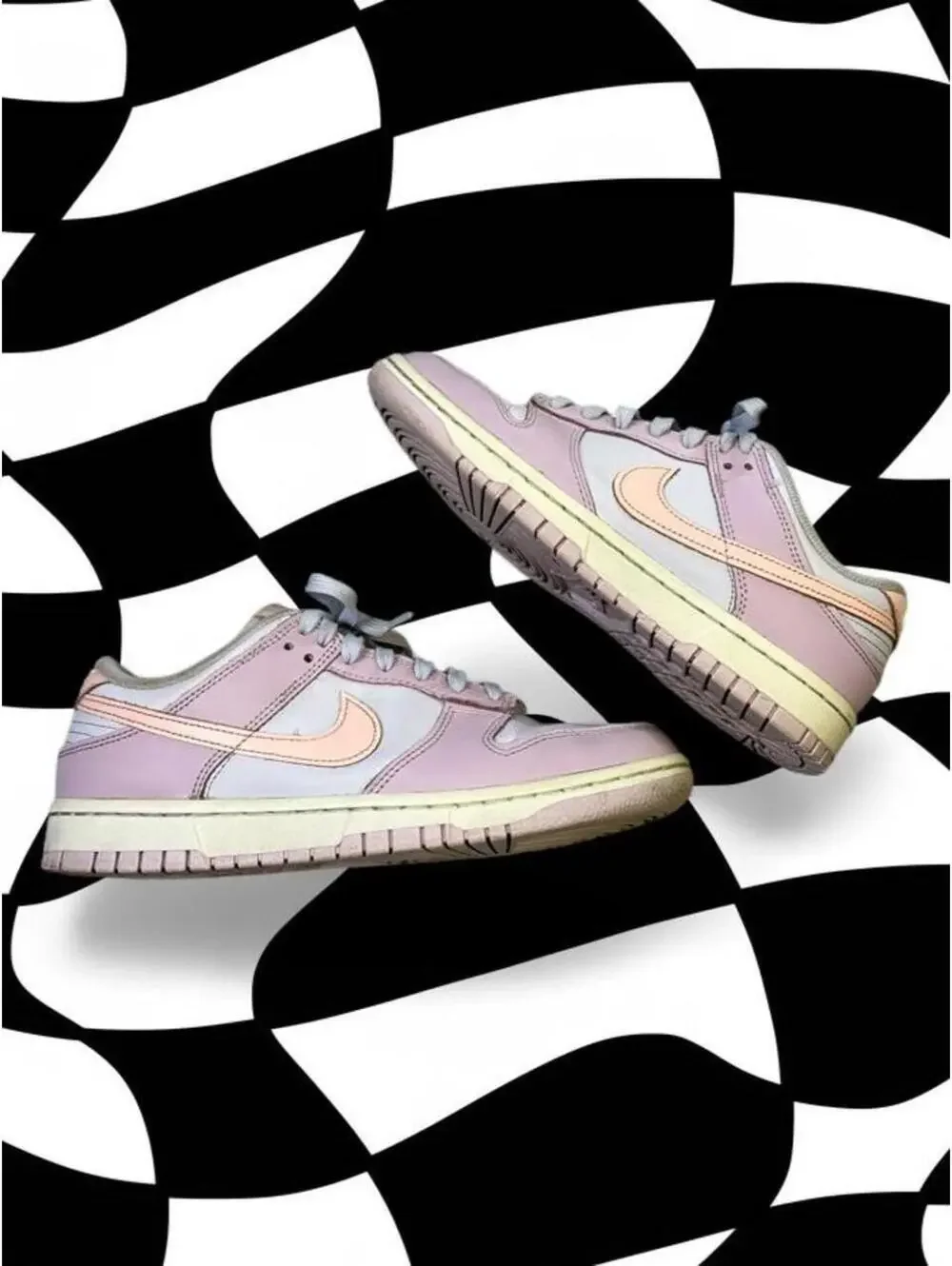 Nike Dunk Low Easter sneakers in pink, white, and peach with a Nike swoosh